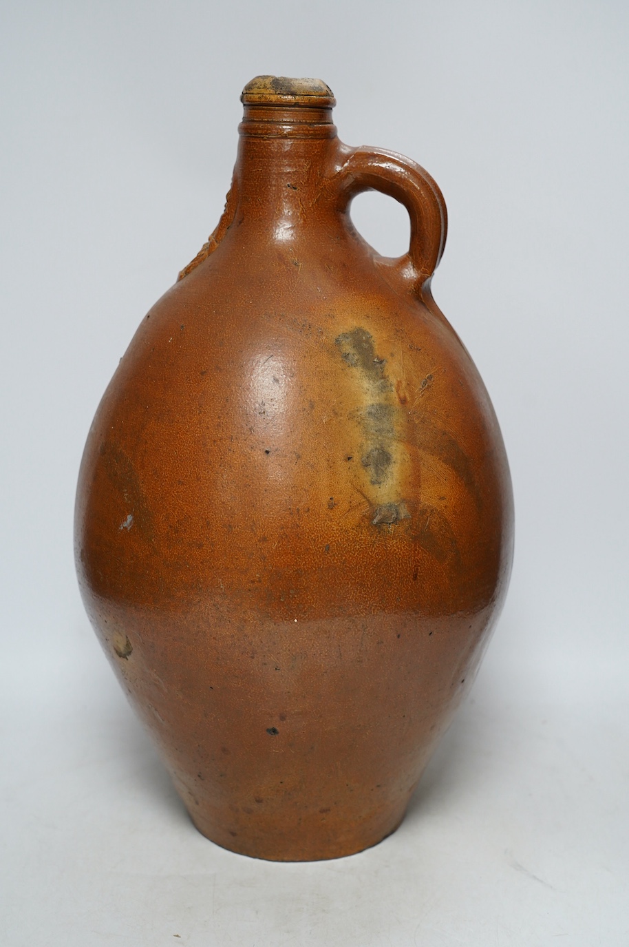 An 18th century German large salt glazed Bellarmine, 45cm. Condition - commensurate with age